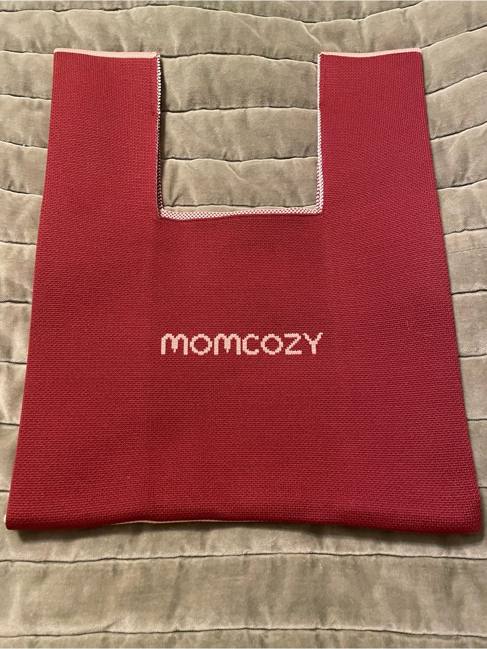 limited edition Momcozy branded tote bag with a knitted texture.
